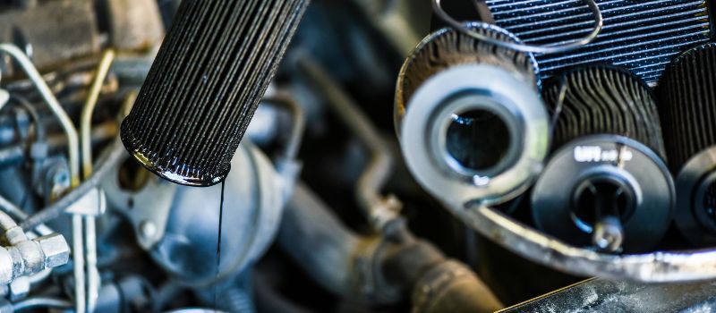 car-mechanic-checking-dirty-engine-oil